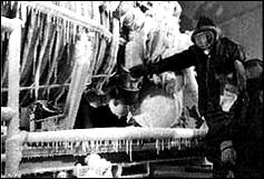 engineers study a J-2 engine that has simulated frigid space conditions