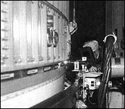 the automatic welding machine makes its slow circuit around the big second stage, carefully monitored by a technician