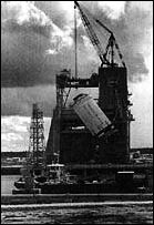 an S-ll stage is hoisted into the test stand at the Mississippi Test Facility