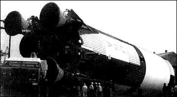 The first S-IC flight stage is cautiously towed through Marshall Space Flight Center on its way to the adjoining Tennessee River and its barge transportation.