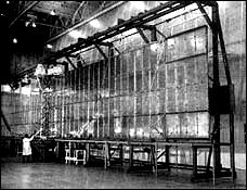a Fairchild technician checks out the extended Pegasus meteoroid detection surface in March 1964.