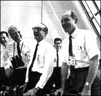in the control room, NASA leaders   Charles W. Mathews, Wernher von Braun, George E. Mueller, and Samuel C. Phillips celebrate the orbiting of Apollo 11