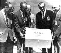 George M. Low, Samuel C. Phillips, Thomas 0. Paine, and Robert R. Gilruth admire the first box of lunar samples to be returned to Earth