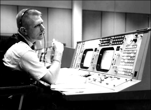 Eugene F. Kranz, flight director, is shown at his console on May 30, 1965, in the Mission Operations Control Room in the Mission Control Center at Houston during a Gemini-Titan IV simulation to prepare for the four-day, 62-orbit flight.