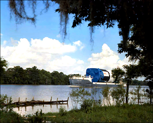 The barge <<Pearl River>> transports the first stage booster of the Apollo Saturn V, the S-IC, along the East Pearl River in 1967 in preparation for testing at the Mississippi Test Facility.