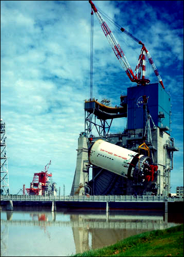 The second stage booster of the Apollo Saturn V, the S-II, is hoisted into the A-2 test stand at the Mississippi Test Facility in 1967.