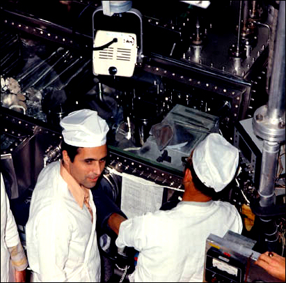 Scientist-Astronaut Harrison Schmitt (facing camera), was one of the first to look at the sample of <<orange>> soil which was brought back from the Taurus-Littrow landing site by the crew of Apollo 17.