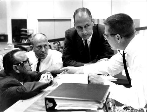 A 1966 photo taken in Mission Control at Houston shows (left to right) Chris Kraft, Bob Thompson, George Low, and Bill Schneider.