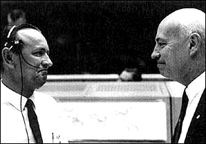 Flight director Chris Kraft (left) and Dr. Robert Gilruth, MSC director, exchange congratulations in the Mission Control Center after learning that Astronauts L. Gordon Cooper Jr. and Charles <<Pete>> Conrad Jr. had been recovered in the western Atlantic to conclude the successful eight-day Gemini V mission on August 29, 1965.