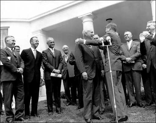 Dr. Gilruth receiving congratulations from NASA's Associate Director Walter C. Williams, Astronaut Alan B. Shepard, Jr. and Astronaut John H. Glenn, Jr. after President Kennedy presents the <<President's Award for Distinguished Federal Civilian Service>> during a special ceremony conducted for Gilruth on the lawn of the White House on August 7, 1962.